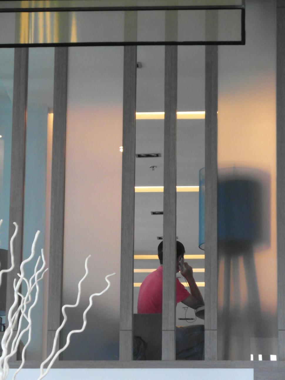 Free Image of Man Talking on a phone in an Office 