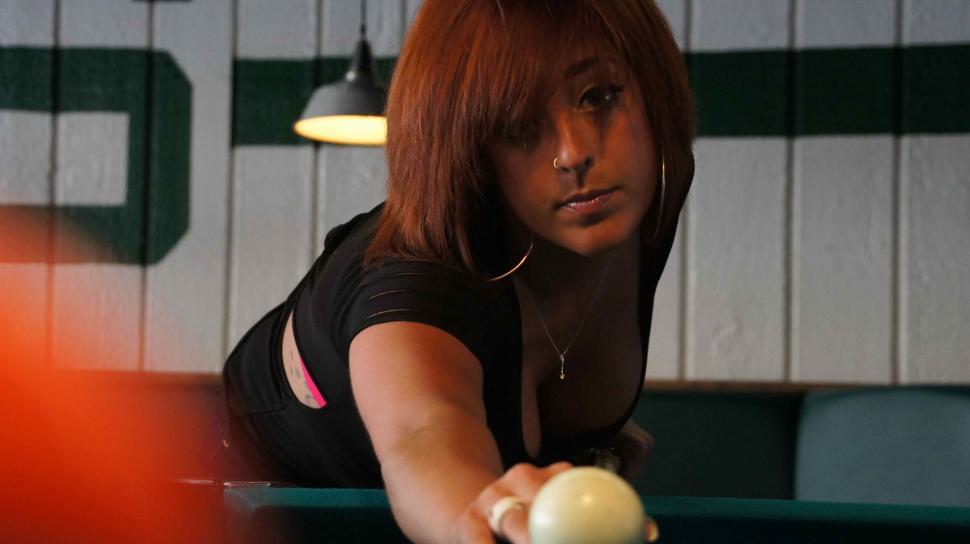 Free Image of Woman with Tattoos Playing Pool 