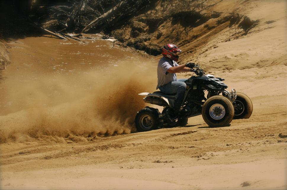 Free Image of ATV Climbs Sand Hill 