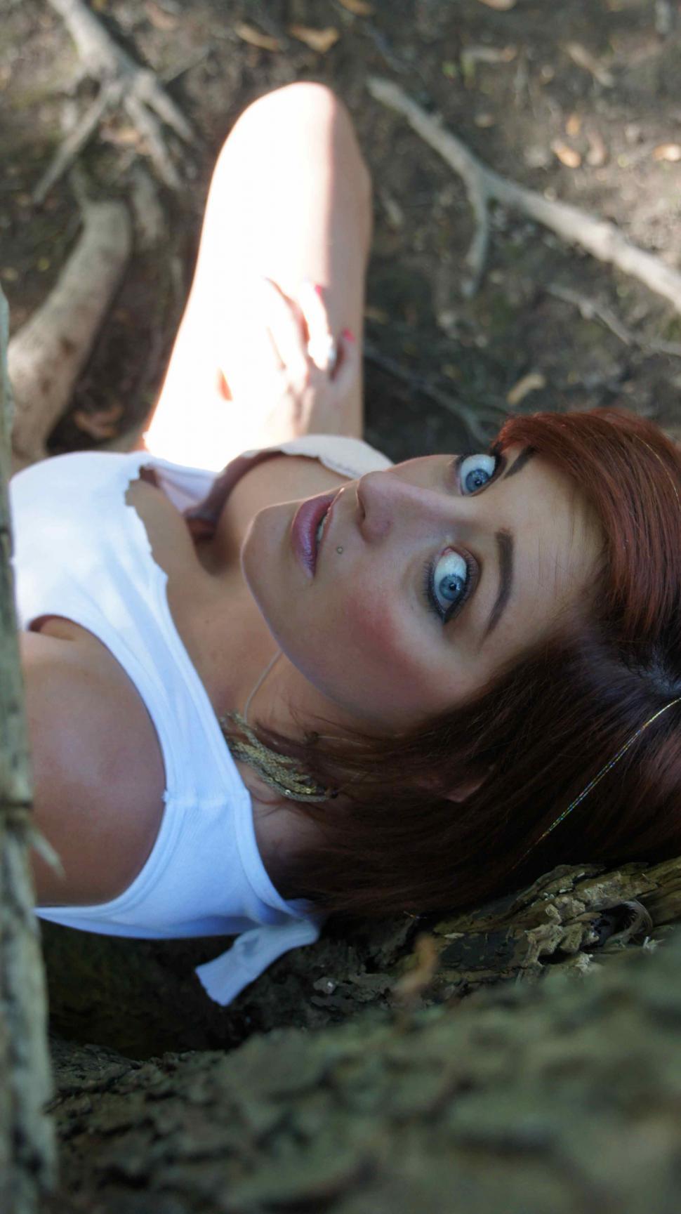 Free Image of woman Outside Hiding Under a Tree 