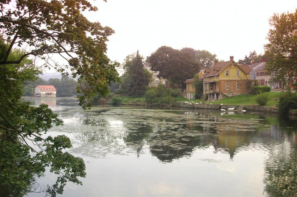 Free Image of A Reflection casts mirror images of a small Pennsylvania Town 