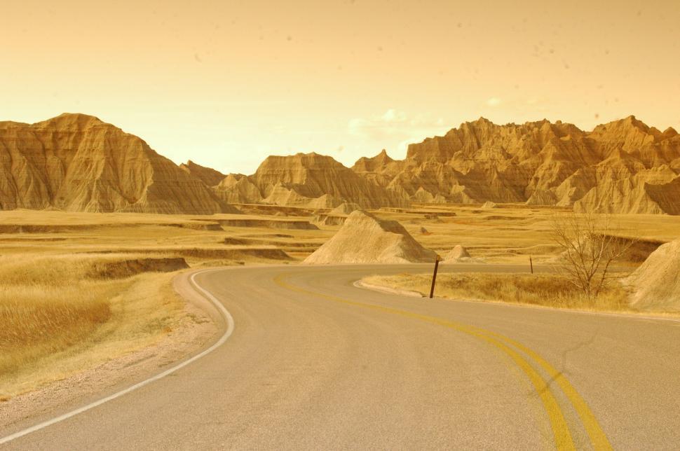 Free Image of Lonely Desert Road through the Badlands 