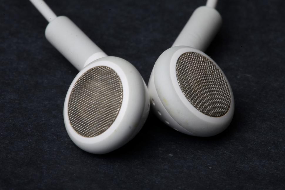 Free Image of White earphones on black background 