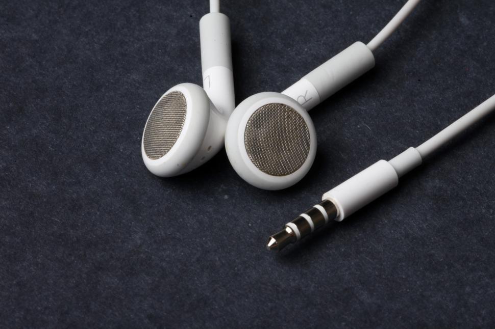 Free Image of White earphones on black background 