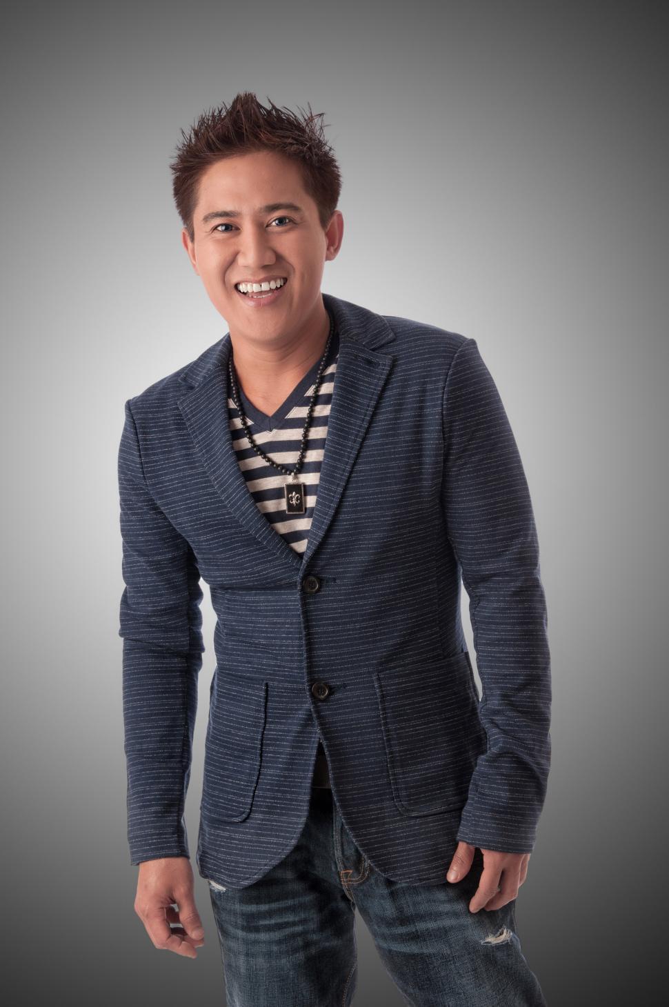 Free Image of Young stylish Asian man smiles at camera 