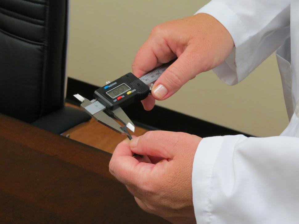 Free Image of Caliper measuring a plastic part 