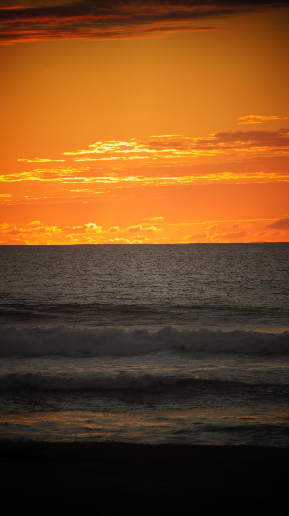 Free Image of Waves in the sunset.  