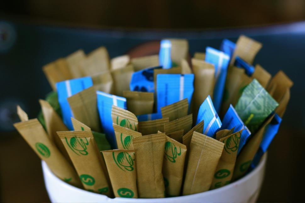 Free Image of White Cup Filled With Brown and Blue Bags 