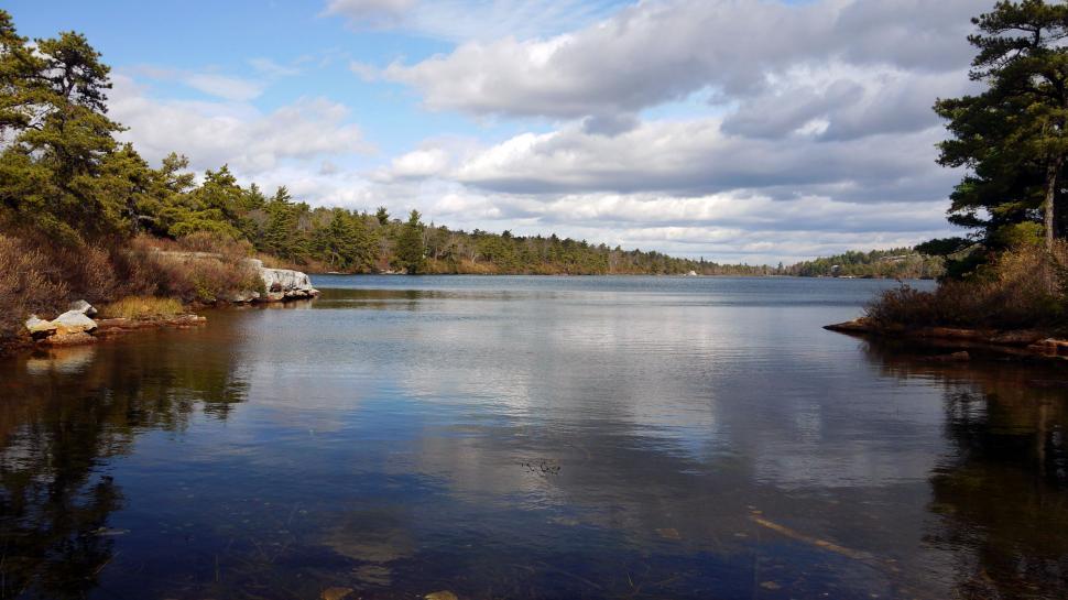 Free Image of Dark clouds moving over a peaceful lake 