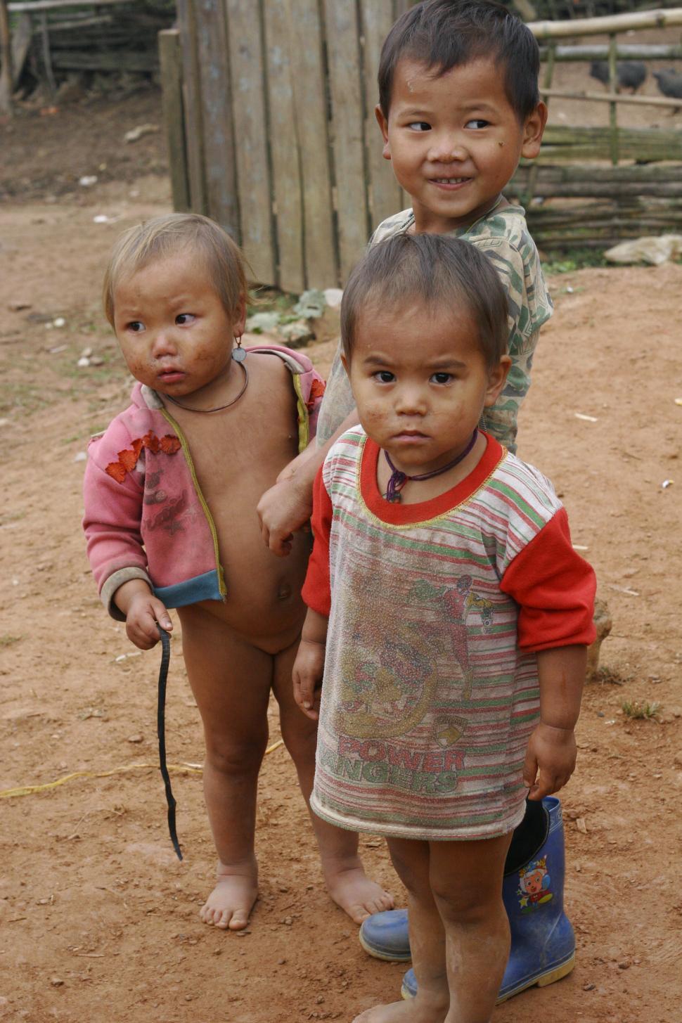 Free Image of Three Small Children Standing Together 