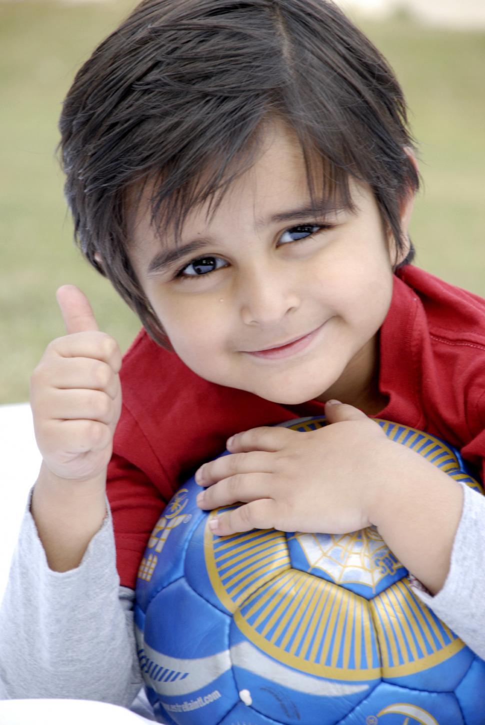 Free Image of Cute Child Showing Thumbs Up 