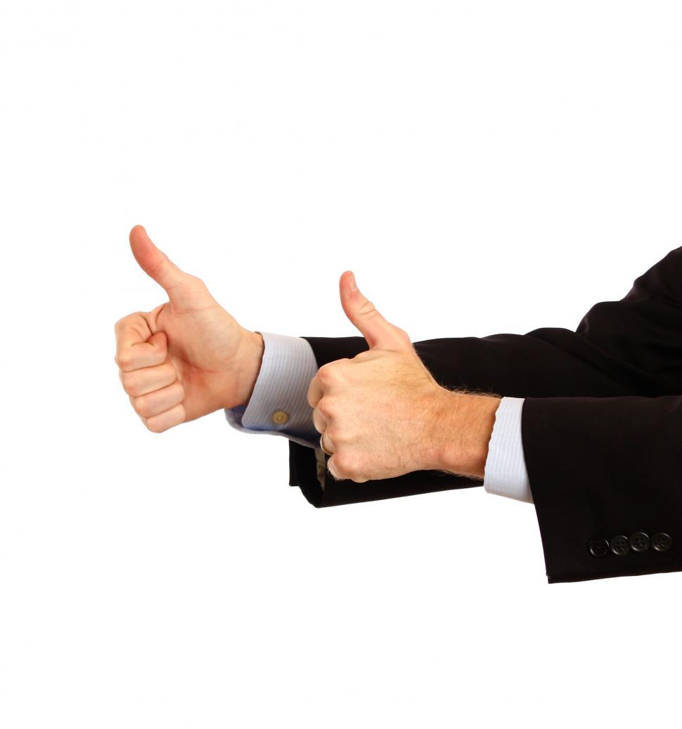 Free Image of A young businessman making a thumbs up gesture 