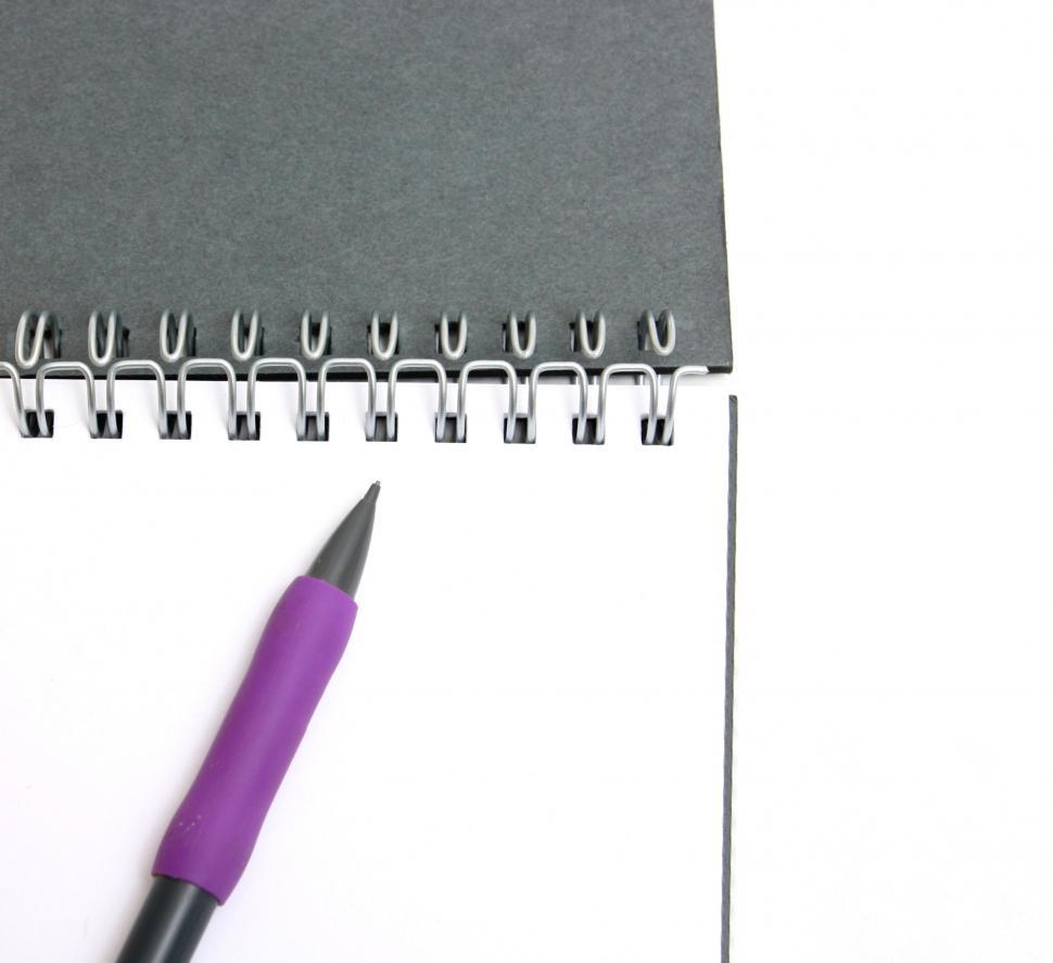 Free Image of A pad of paper and a pencil isolated on a white background 