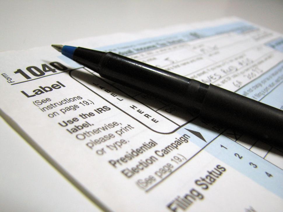 Free Image of Closeup of a 1040 tax form and a pen 