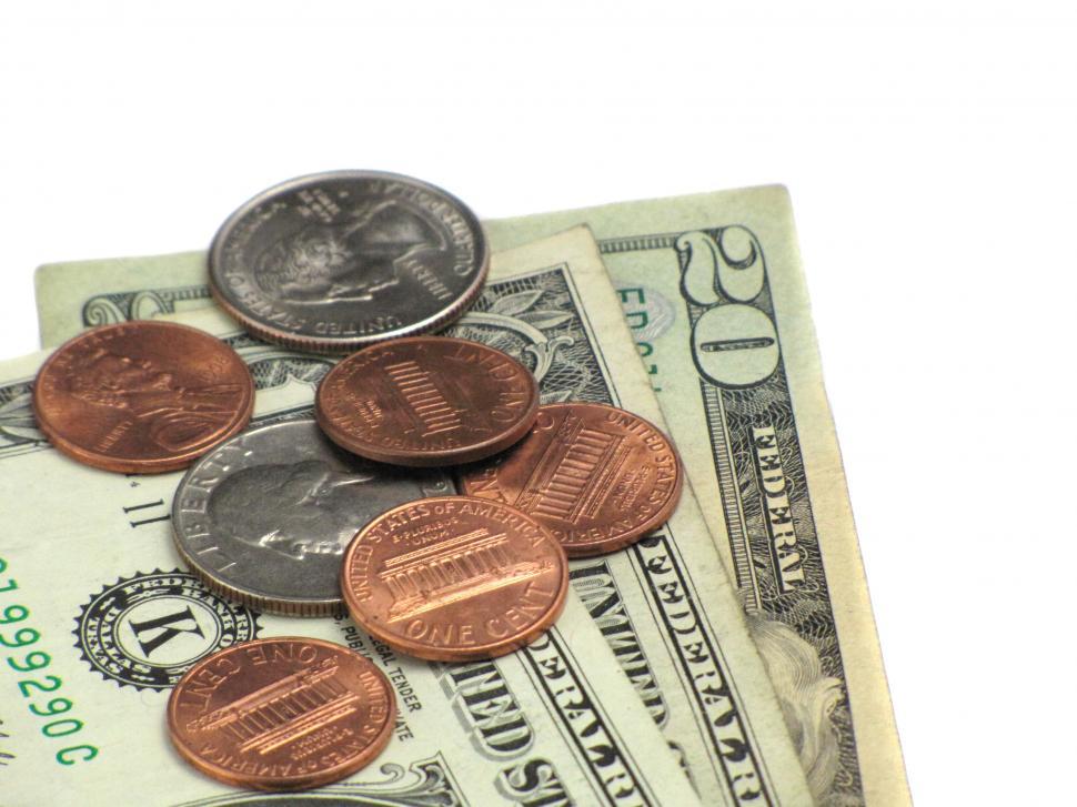Free Image of Close-up of some dollars and coins on a white background 