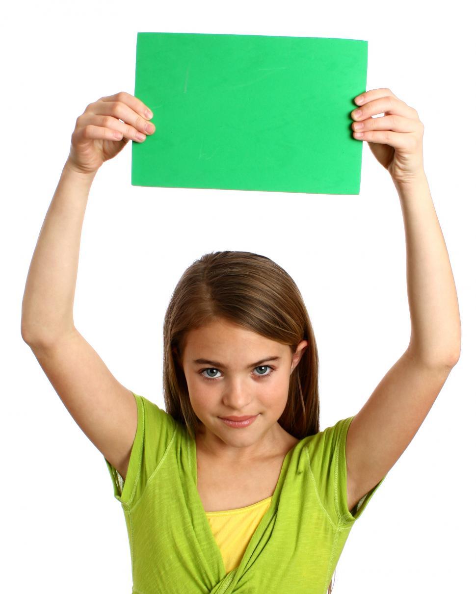 Free Image of A beautiful young girl holding a blank green sign 