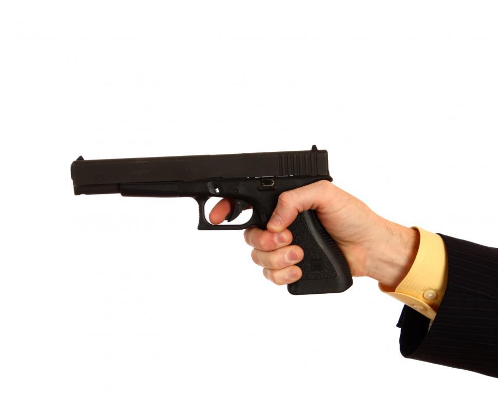 Free Image of A hand in a business suit holding a pistol 