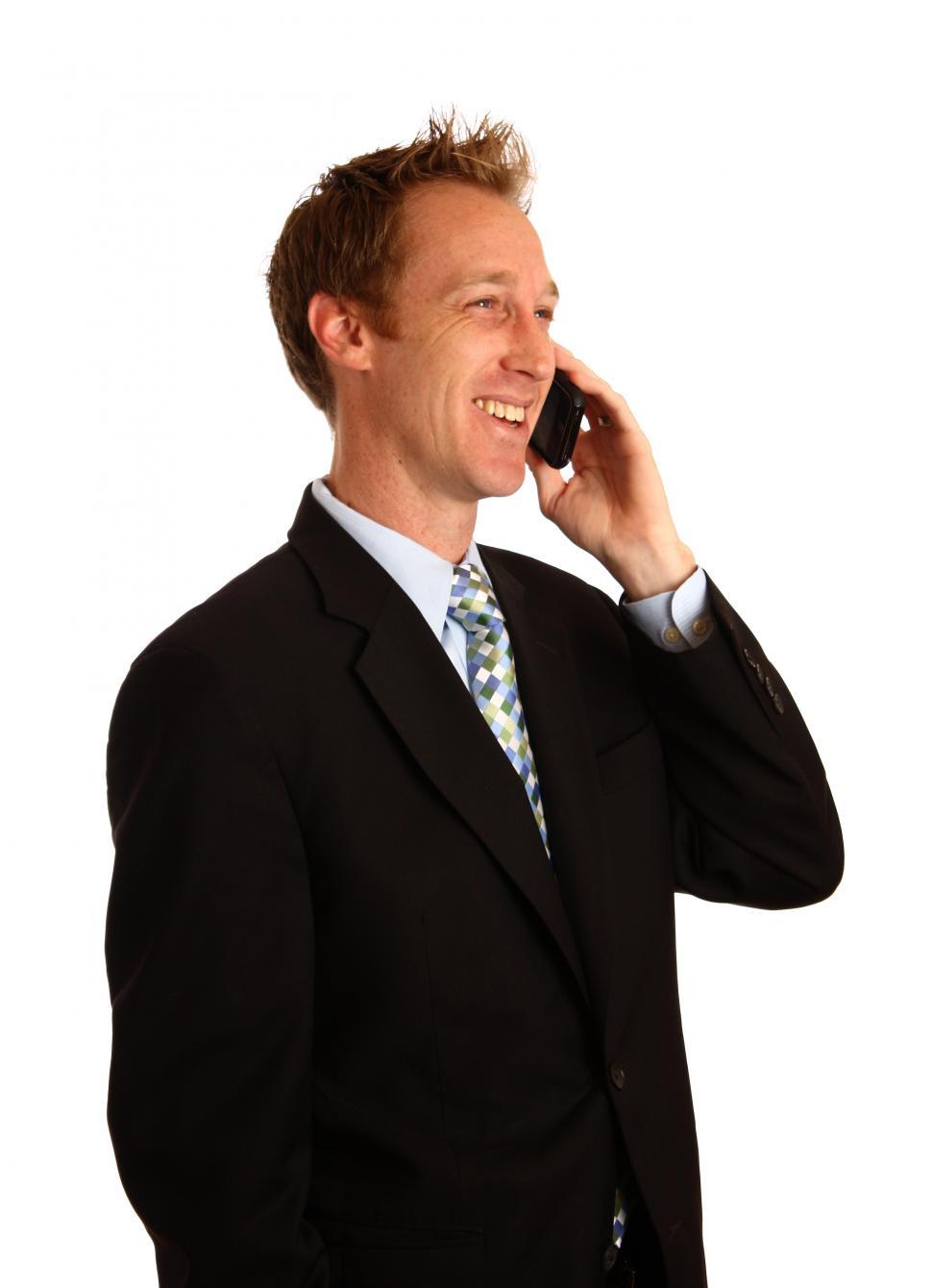 Free Image of A young businessman talking on a cell phone 