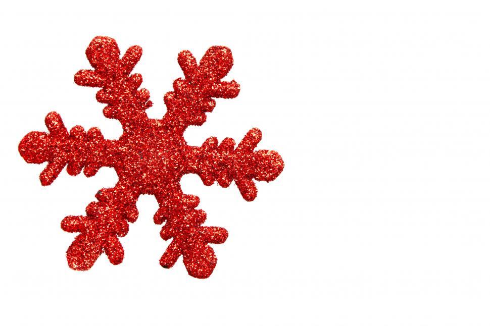 Free Image of A red snowflake shaped Christmas ornament isolated on a white background 