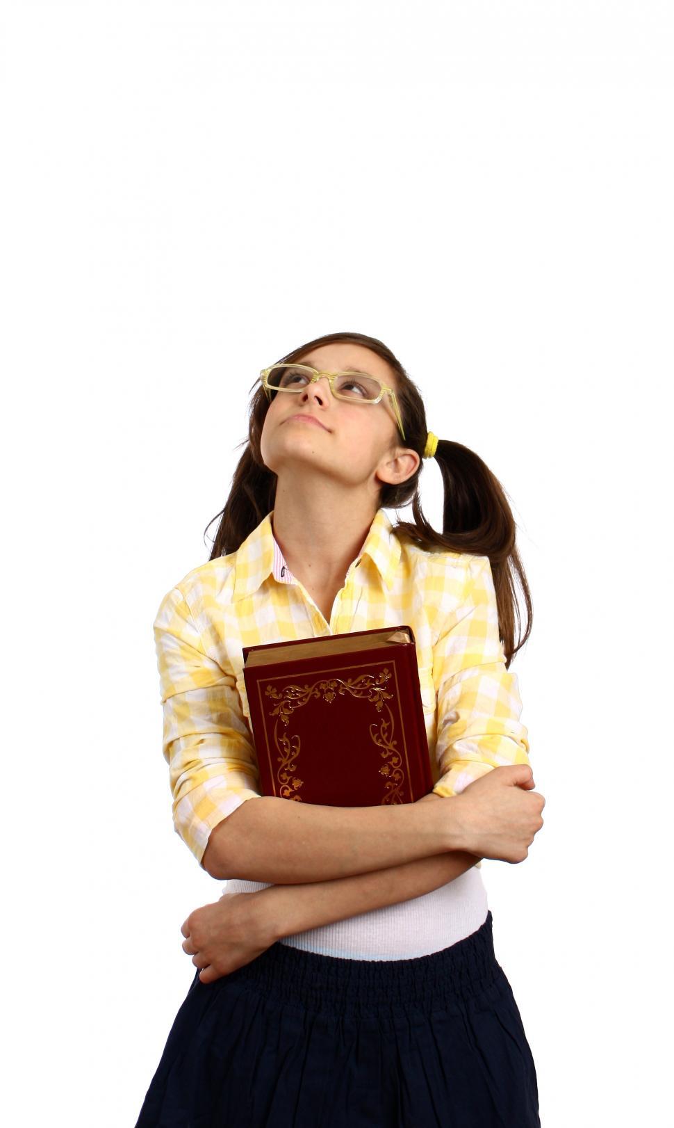 Free Image of A smart girl with glasses holding a book 