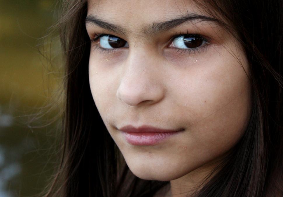 Free Image of A beautiful young girl posing outdoors 