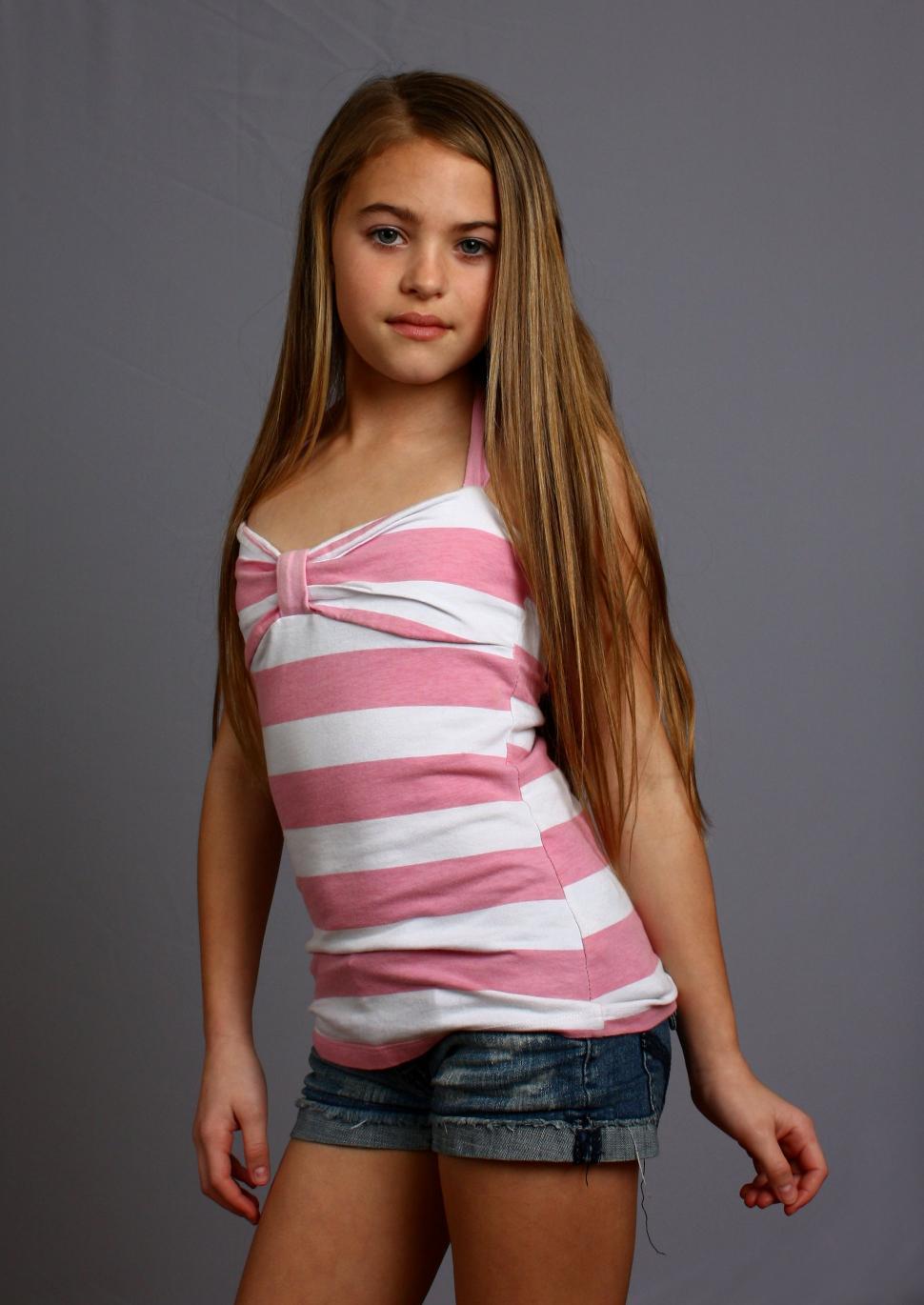 Free Image of A beautiful young girl posing on a gray background 
