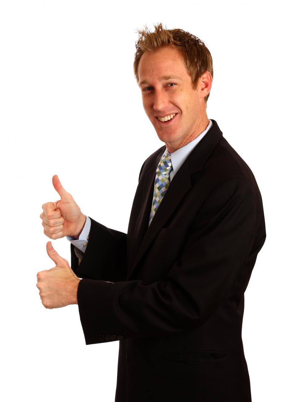 Free Image of A young businessman giving a thumbs up signal with his hands 