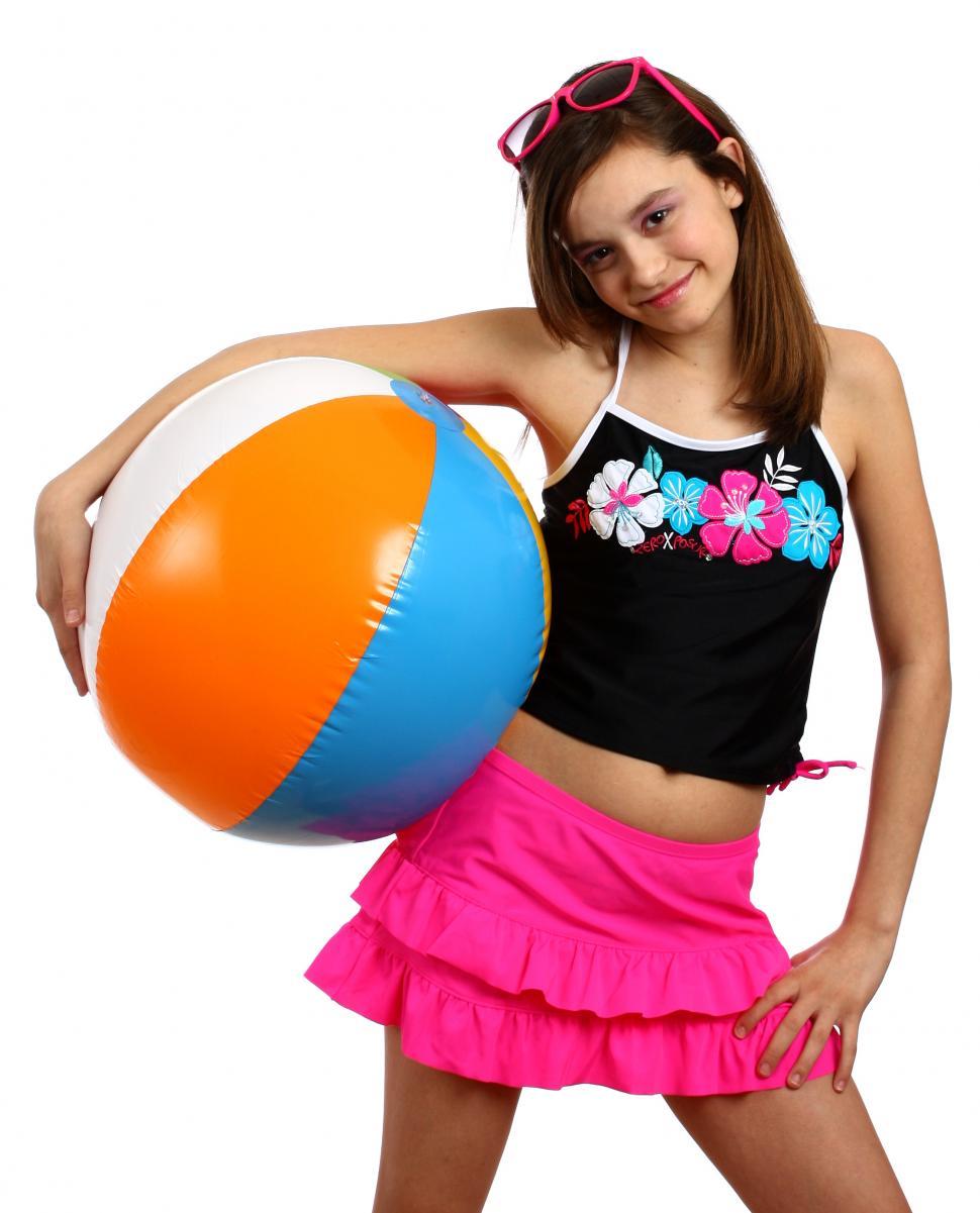 Free Image of A cute young girl posing with a beach ball 