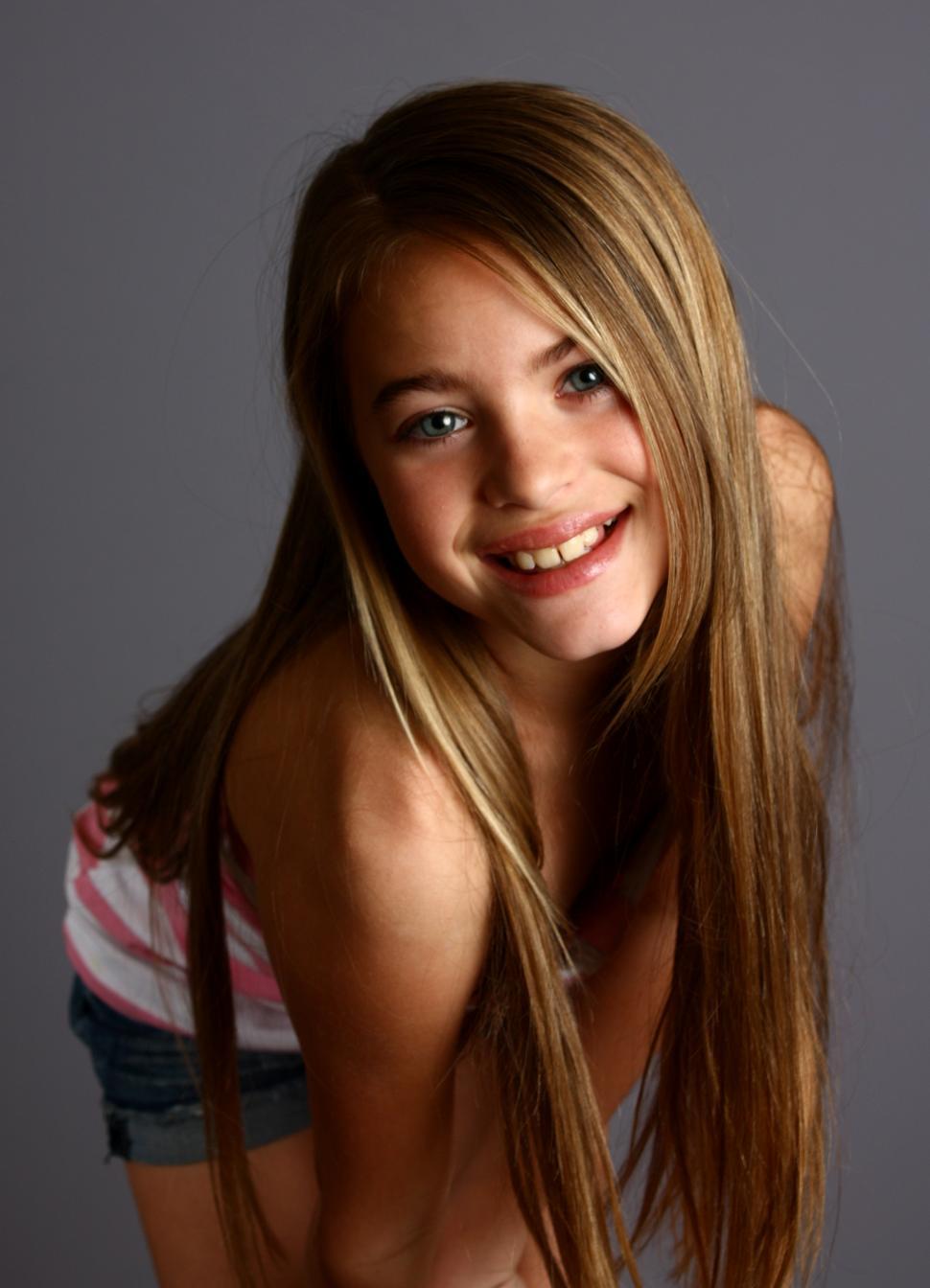 Free Image of A beautiful young girl posing on a gray background 