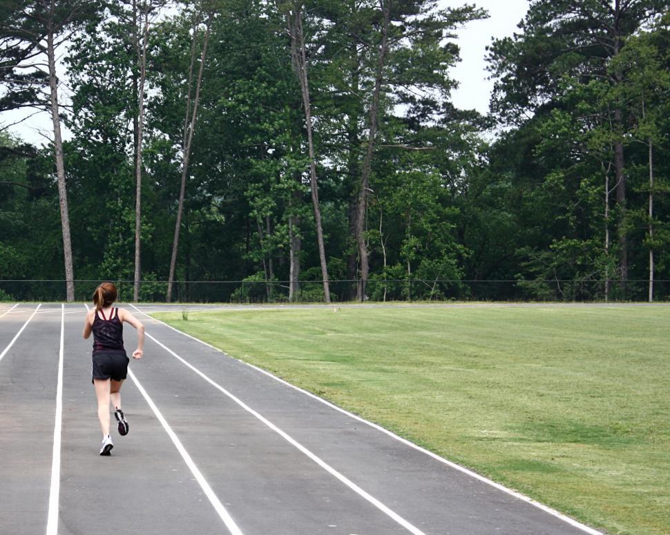 Free Image of A cute young girl on a track field 
