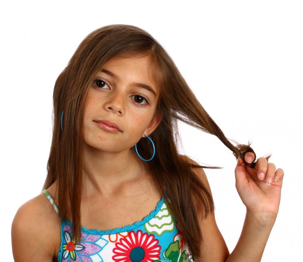 Free Image of A pretty young girl pulling on her hair 