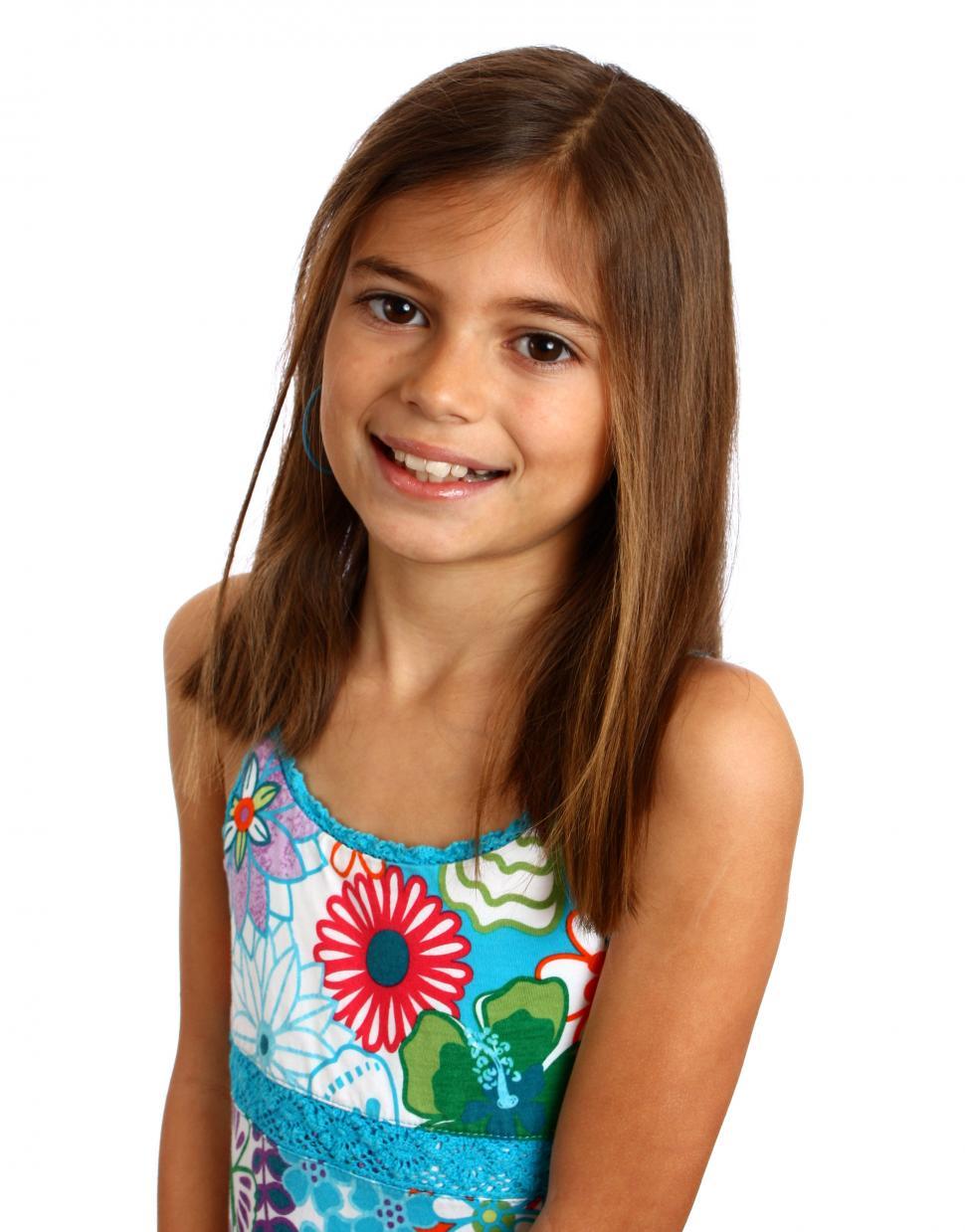 Free Image of A pretty young girl posing with a white background 
