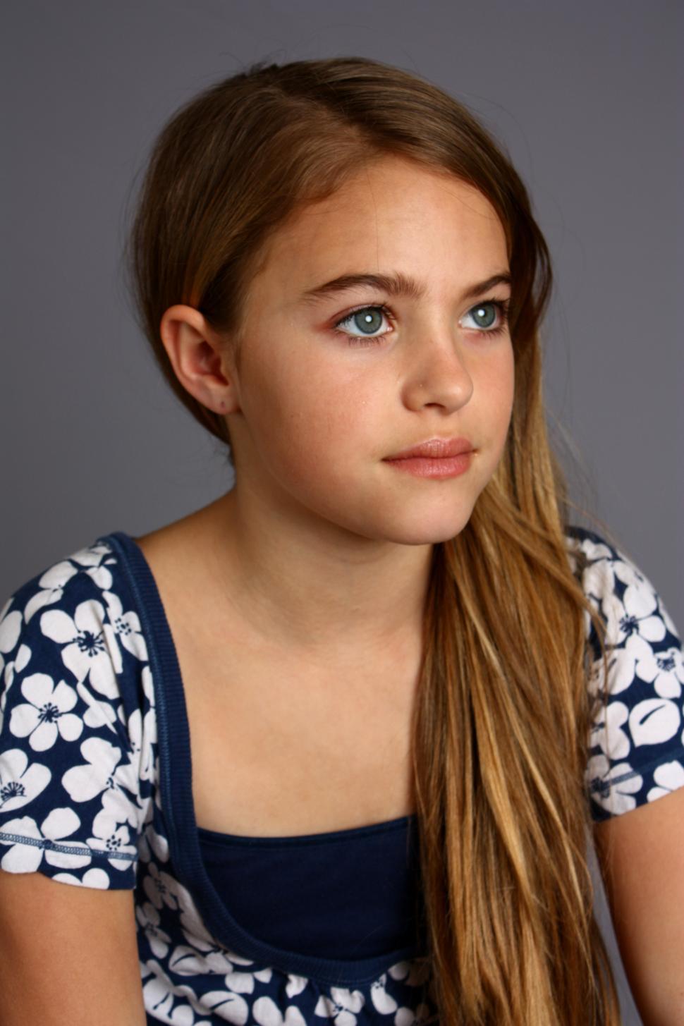 Free Image of A beautiful young girl posing with a gray background 