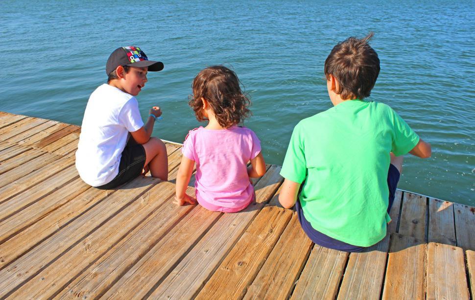Free Image of A boy trying to convince two kids of something  