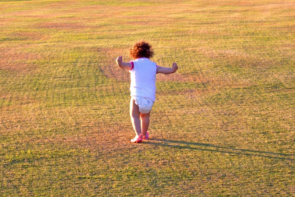 Free Image of Baby with diapers pretending to be a bird 
