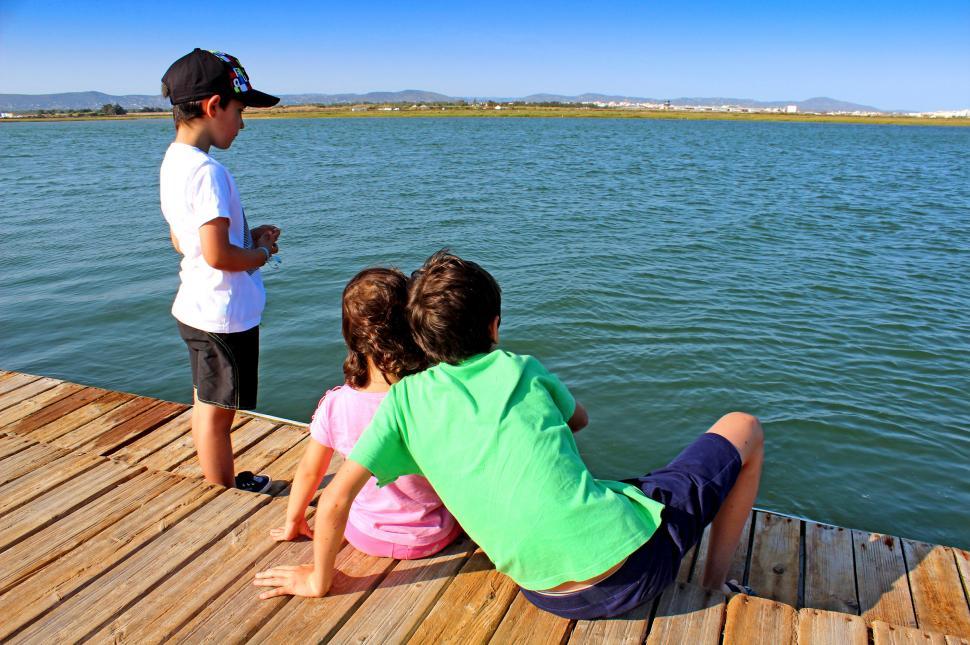 Free Image of Close brothers and friend on the pier 