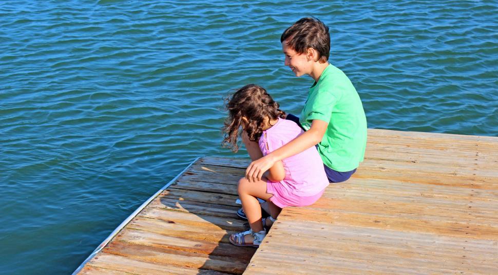 Free Image of Companionship - older brother embracing little sister on the pie 