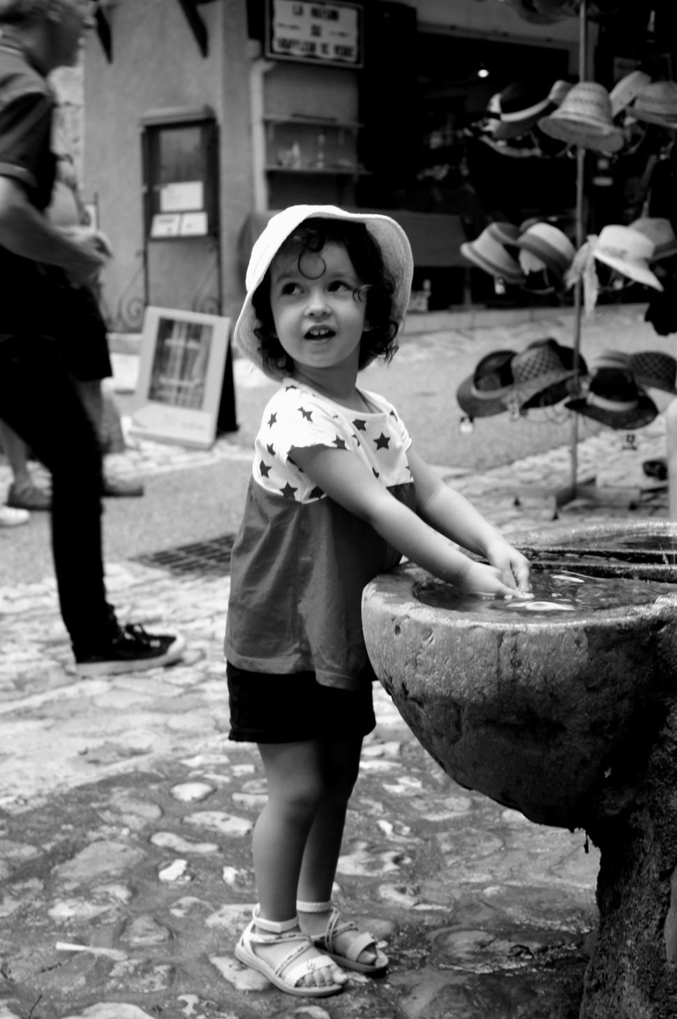 Free Image of Young child washing her hands in the typical village of Moustiers 