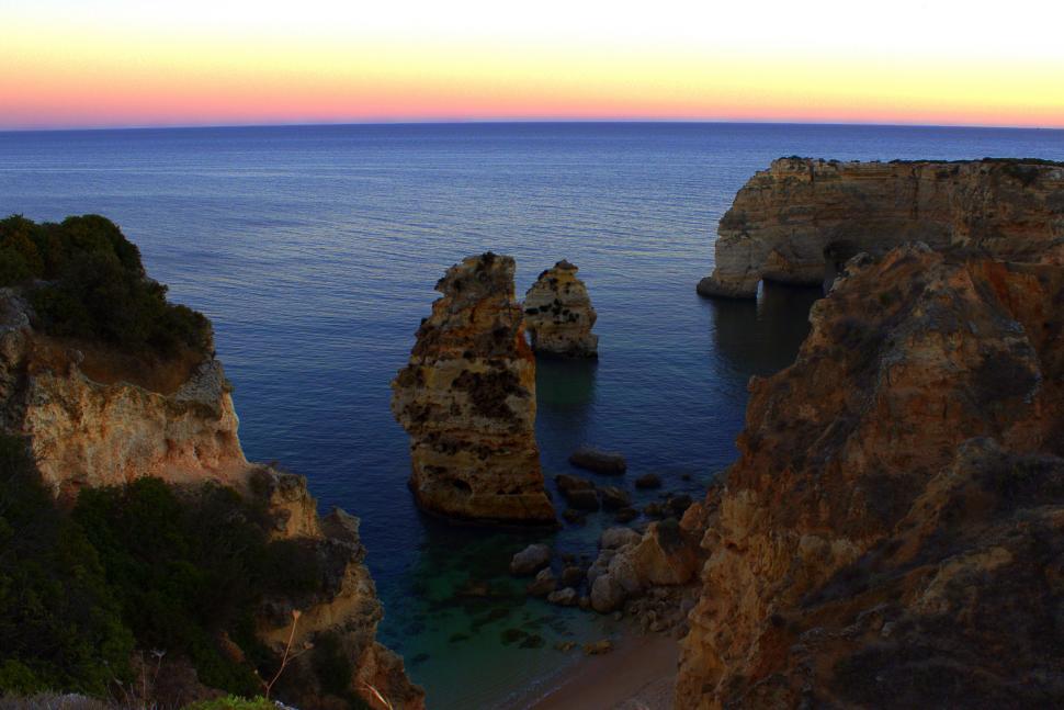 Free Image of Sea stacks and sandstone cliffs at dusk - secluded beach in Prai 