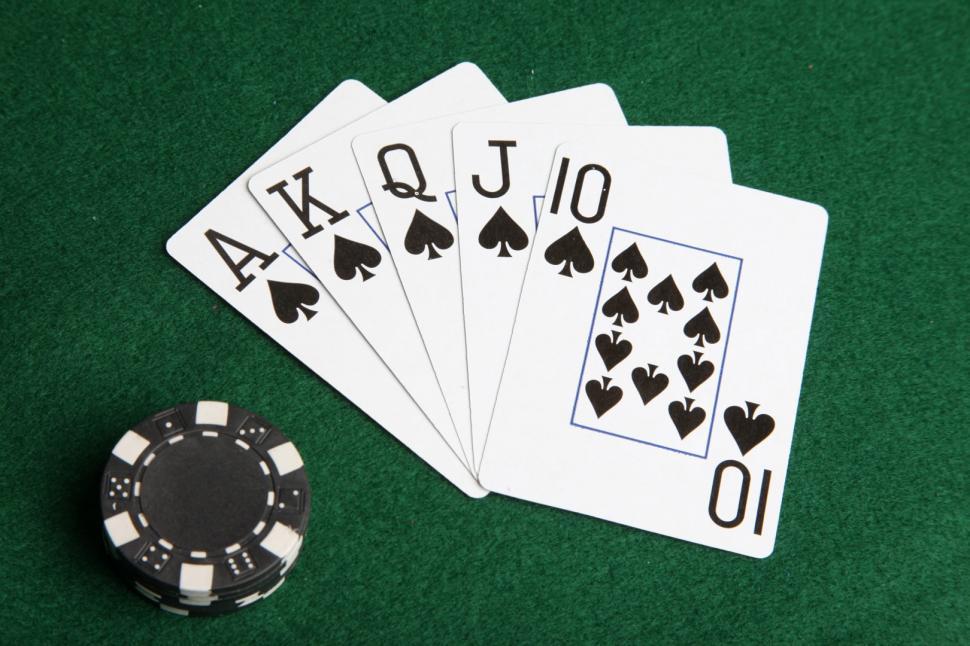 Free Image of Royal flush of spades with black poker chips. 