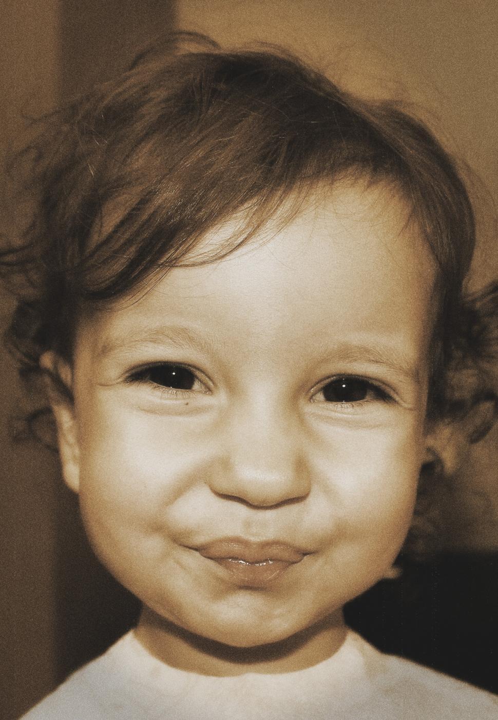 Free Image of Toddler smiling in a funny and sweet way - slightly aged sepia t 