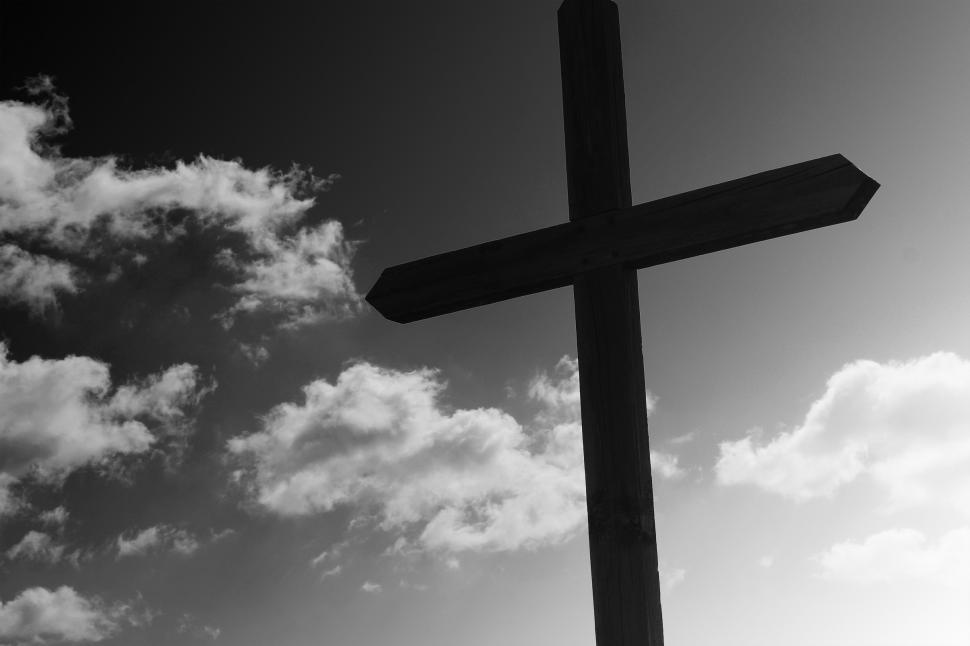 Free Image of Wooden cross against a cloudy sky  