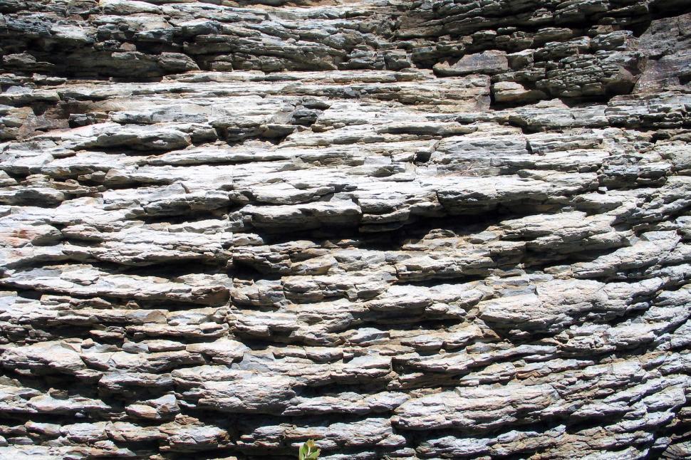Free Image of Close Up of Stone Wall With Black and White Picture 