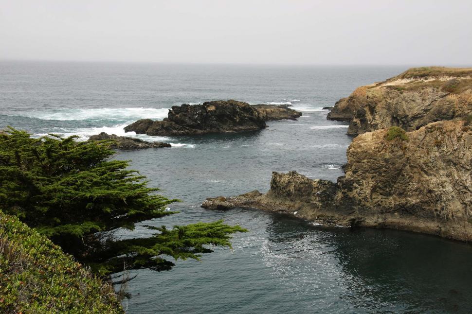 Free Image of Body of Water Surrounded by Rocks and Trees 