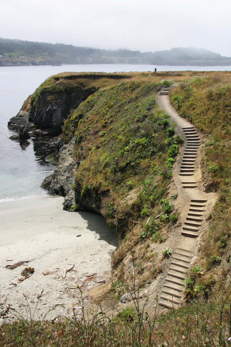 Free Image of Path Leading to Beach Next to Ocean 