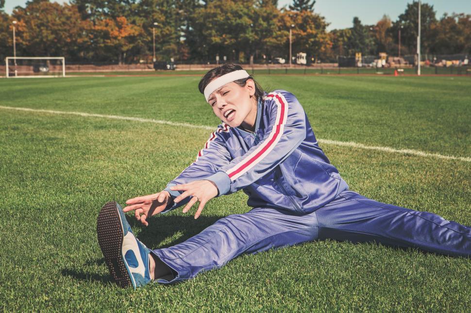 Free Image of Female Athlete trying to stretch 