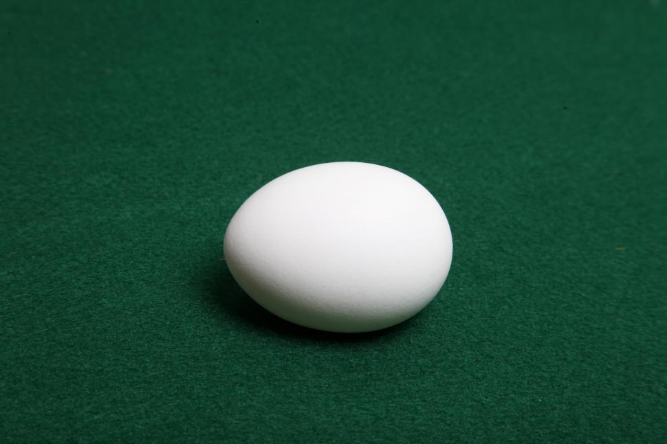 Free Image of Single White Egg on green felt 