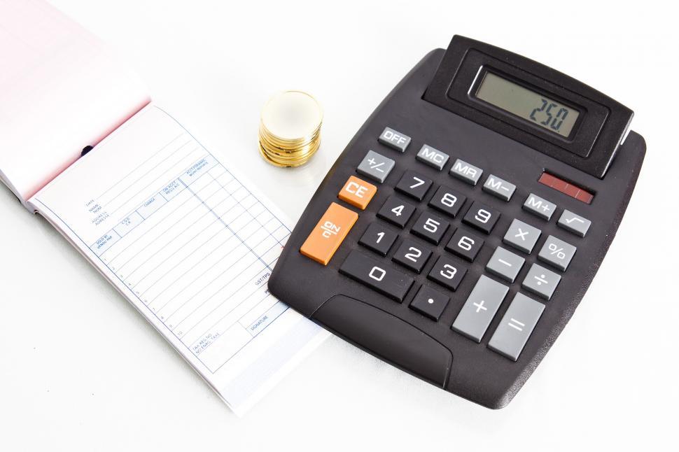 Free Image of Receipt book with calculator and coins 