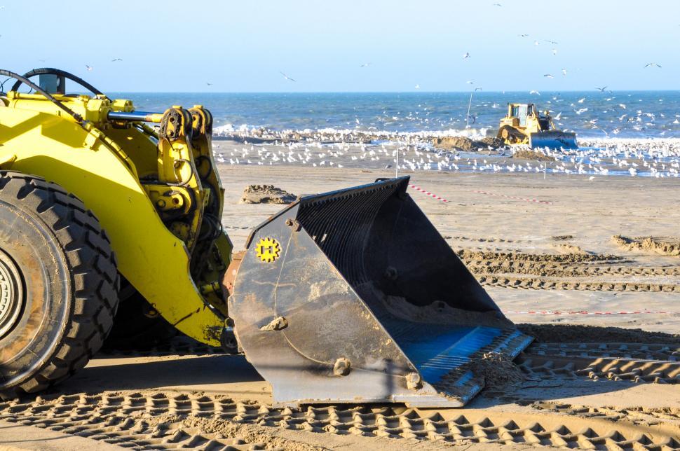Free Image of bulldozer working on a beach 