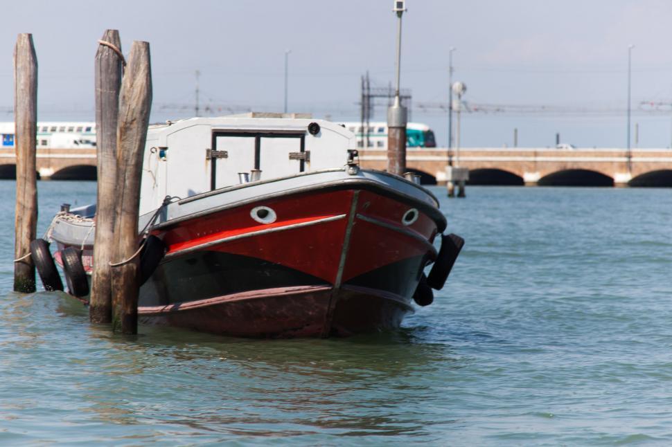 Free Image of Moored boat with train in background 